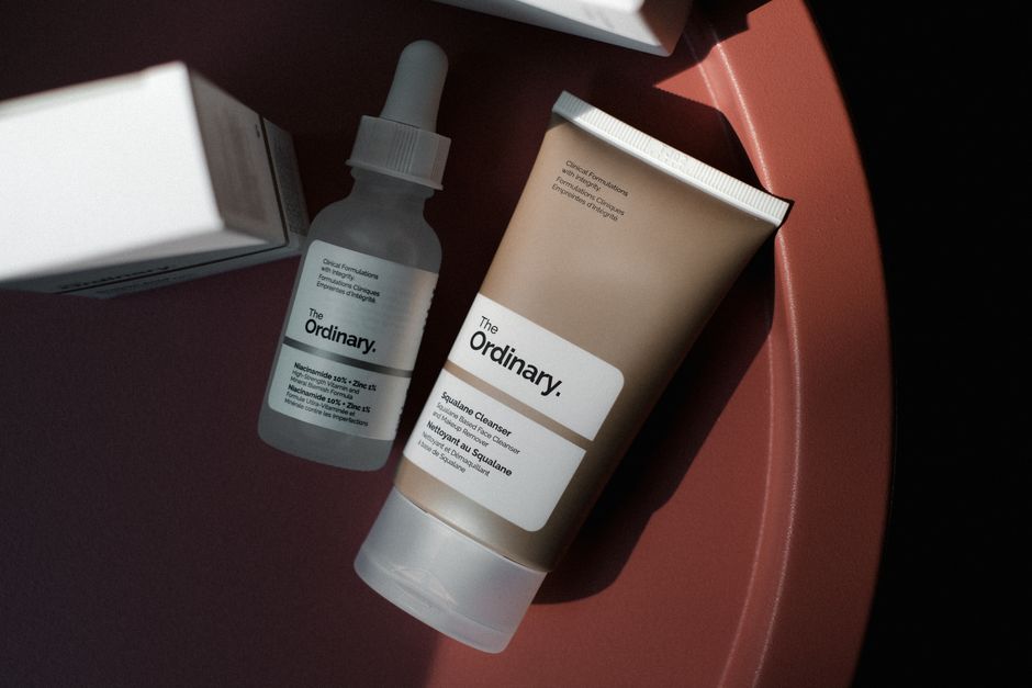 Close-up of a clear skincare serum being applied to glowing skin