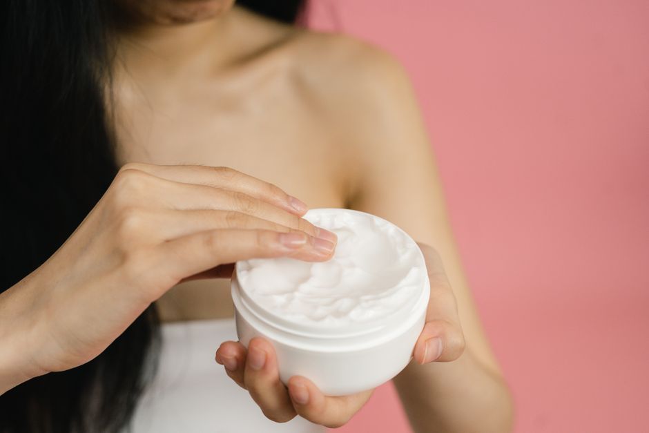 Applying a drugstore moisturizer as part of a skincare routine