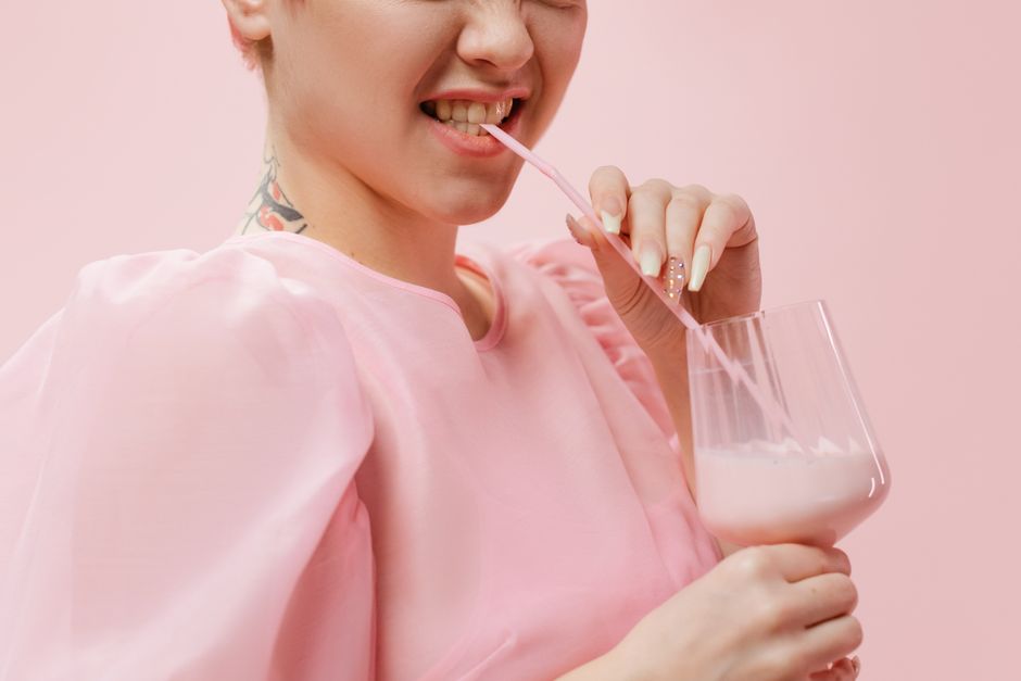 Woman mixing a collagen supplement into a morning smoothie
