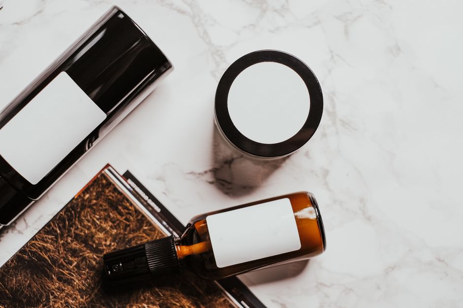 skincare bottles and jars arranged on a bathroom counter