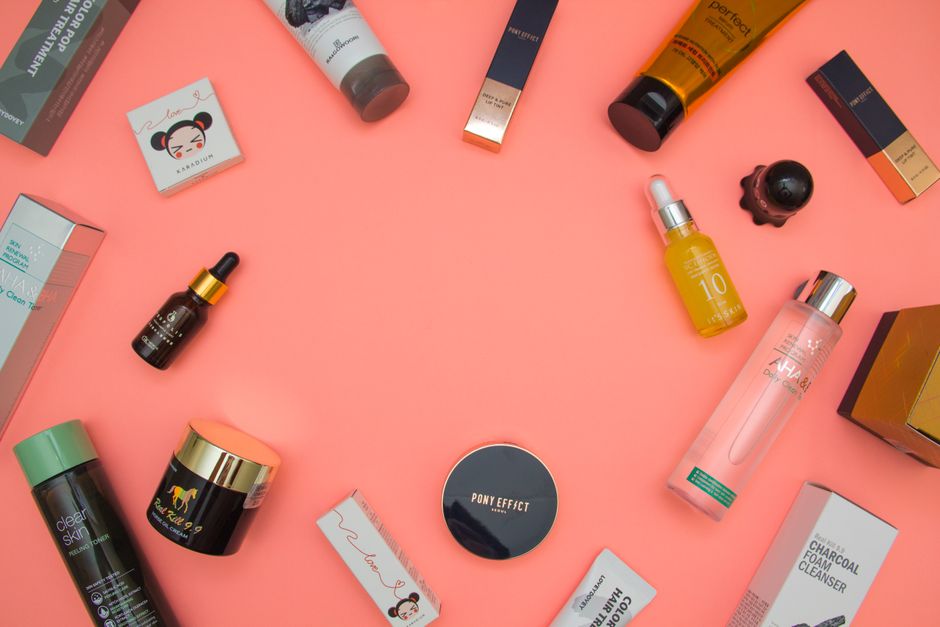 Flat lay of skincare bottles including serum and moisturizer