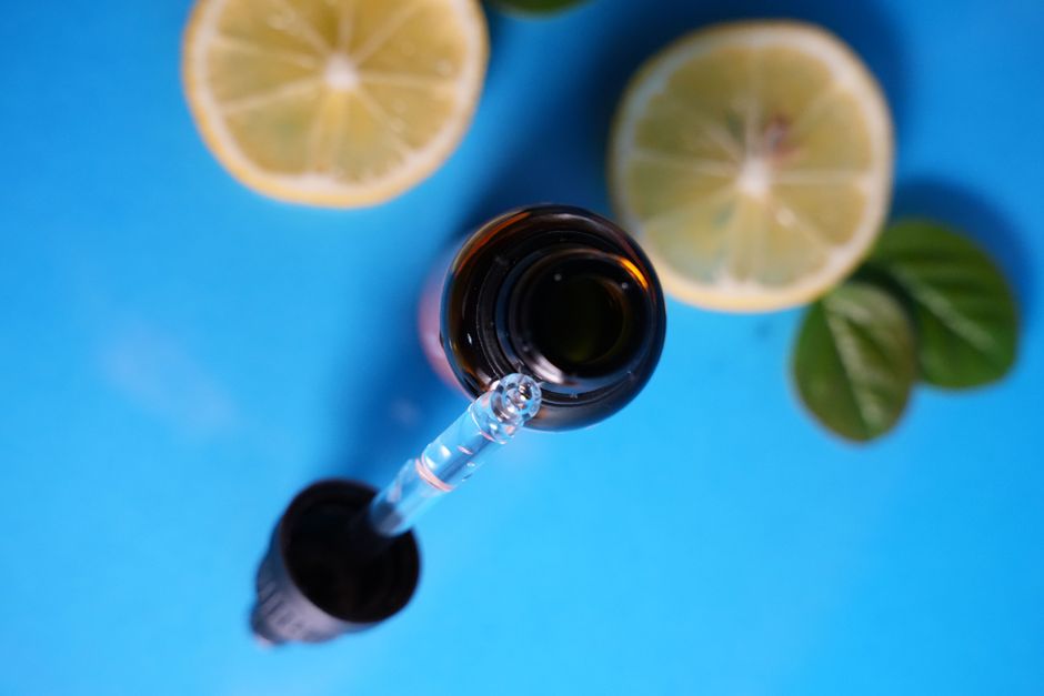 Amber dropper bottle of vitamin C serum on a skincare counter