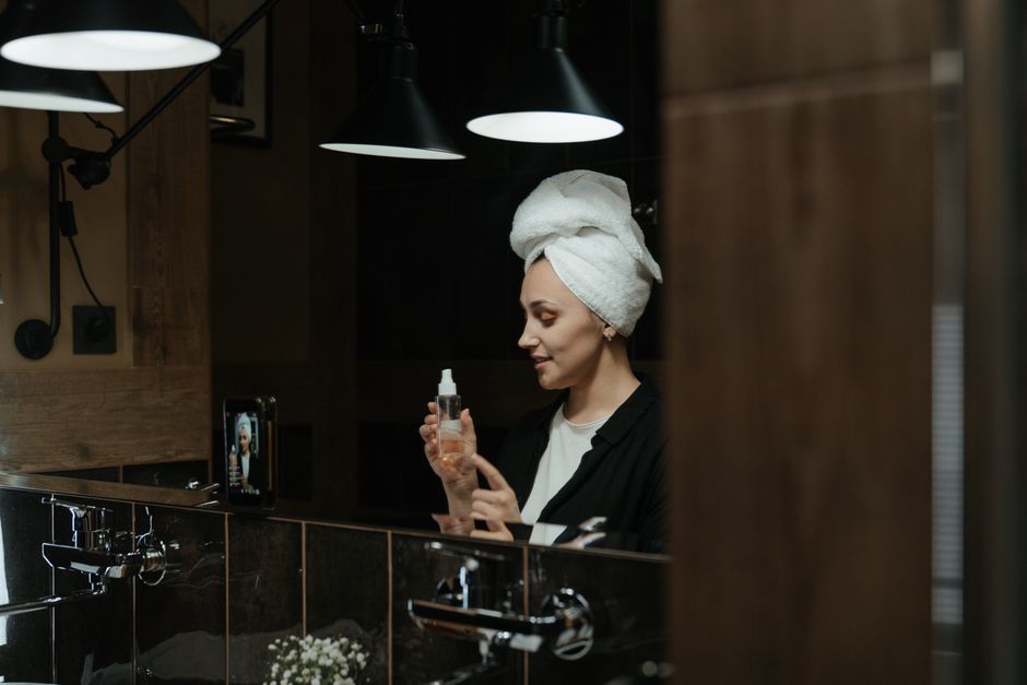 Woman applying retinol serum as part of nighttime skincare routine