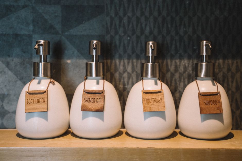 minimalist skincare products lined up on a clean shelf