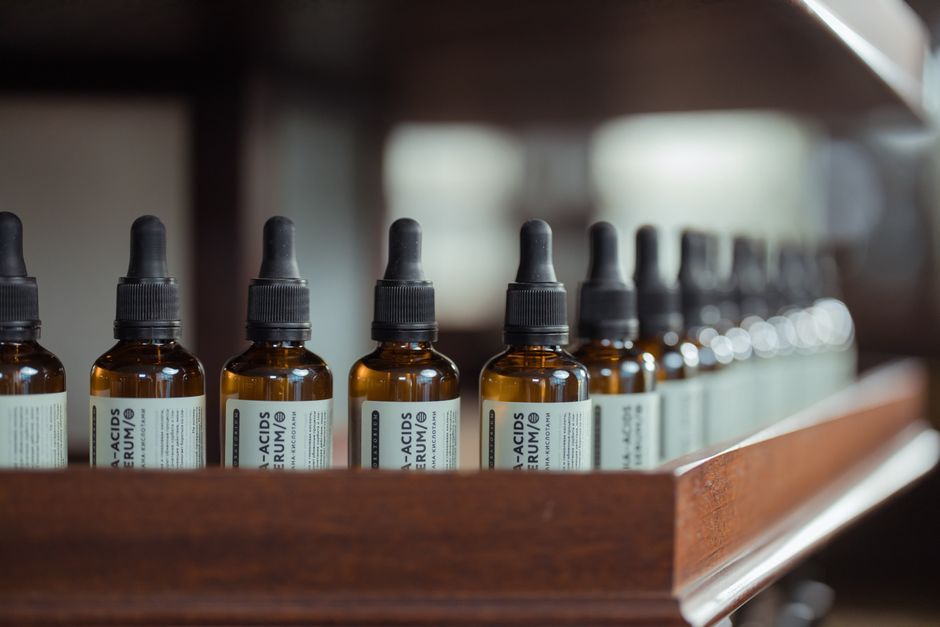 A retinoid serum bottle on a bathroom shelf