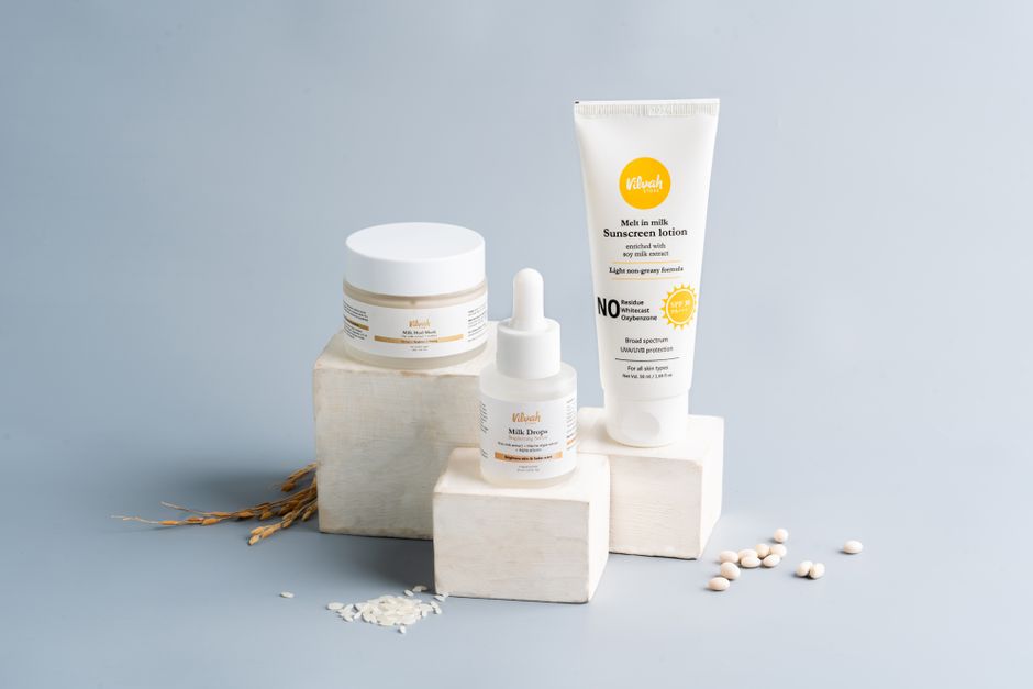 Skincare products including serum, moisturizer, and sunscreen arranged on a counter
