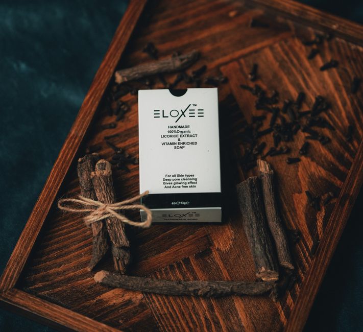 Amber glass dropper bottle of licorice root extract serum on a light background